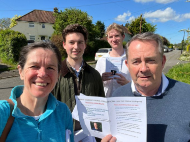 Sir Liam Fox holding a consultation leaflet